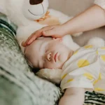 Bambina che dorme con orsacchiotto.- routine del sonno nei bambini